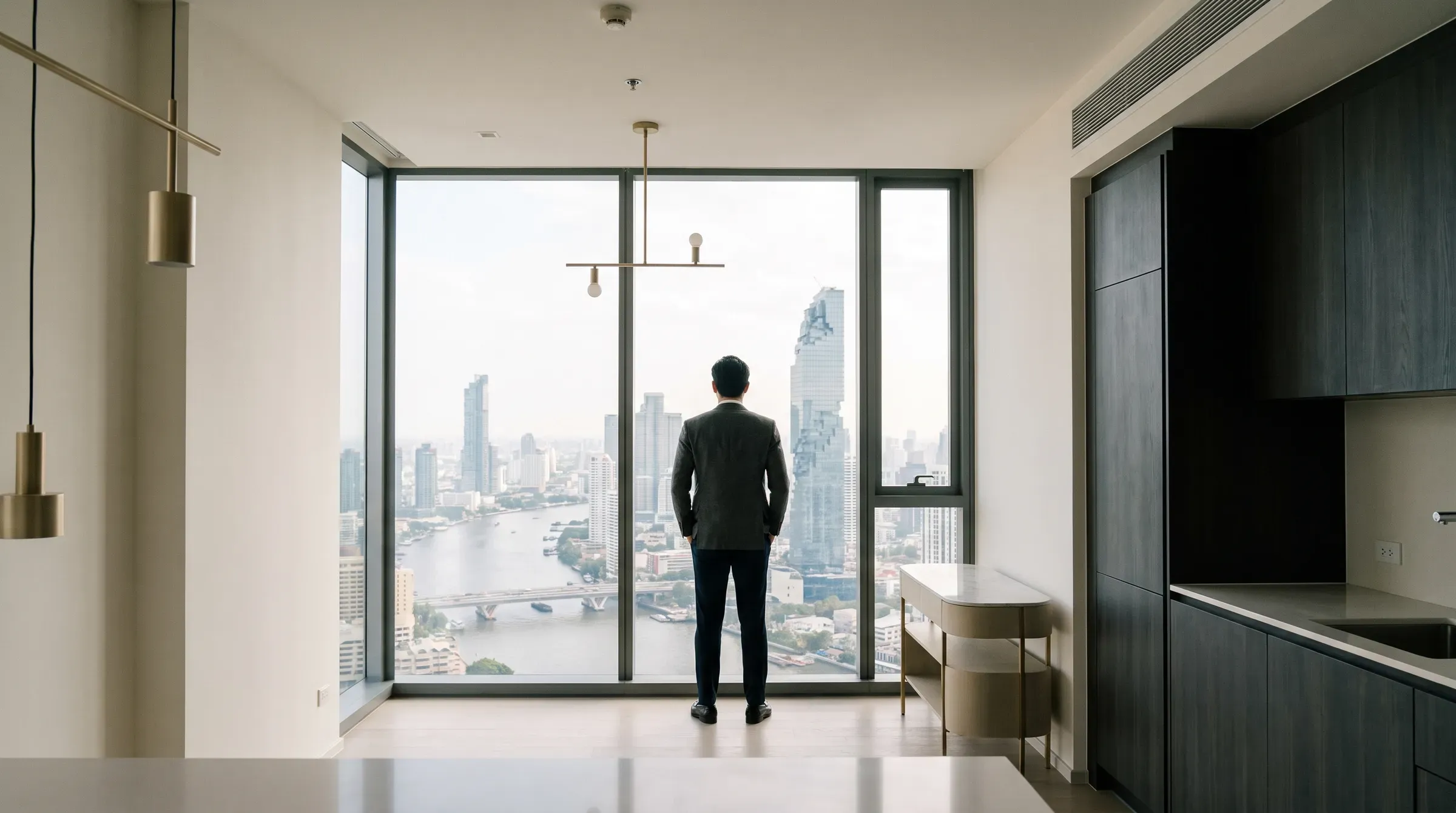 Foreign buyer viewing a Bangkok condo with city views during a property tour
